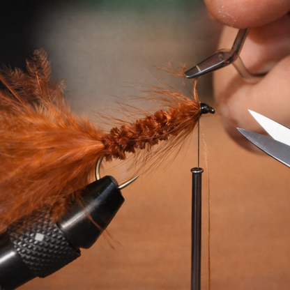 Close-Up of Fishing Fly Construction Adding Fur and Feathers to Create Realistic Lures